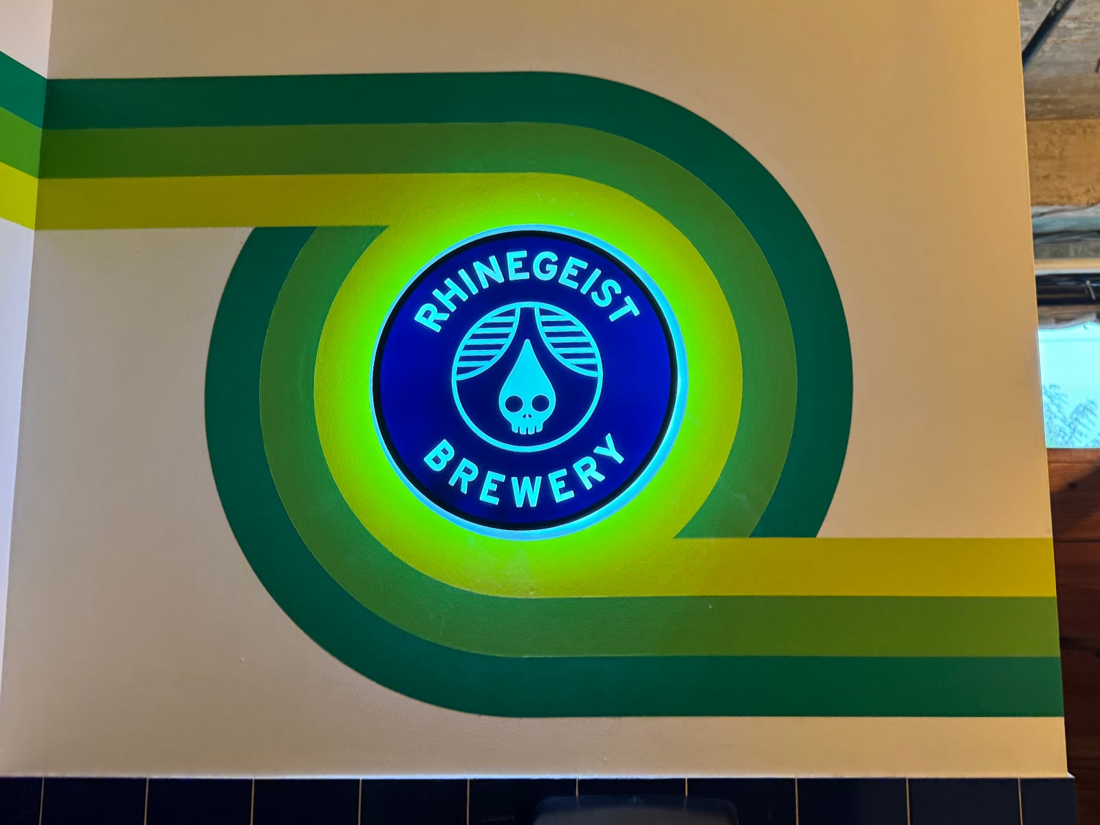 A backlit merchandise sign, modified and hardwired into the room lighting